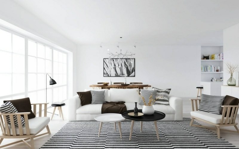 Soggiorno in stile scandinavo in bianco e nero Sterifen come accento Mobili scandinavi soggiorno tappeto originale strisce cuscini morbidi design colore neutro